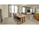 Dining room features a wood table with black chairs and natural light through sheer curtains at 3504 Golden Wheat Ln, Plant City, FL 33565