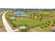 Fenced dog park featuring a grassy area, shaded seating, and a water station for furry friends at 3504 Golden Wheat Ln, Plant City, FL 33565