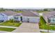 Charming single-Gathering home with a manicured lawn, three-car garage, and inviting front porch at 3504 Golden Wheat Ln, Plant City, FL 33565