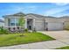 Charming single-story home with three-car garage, well-manicured lawn, and appealing landscaping at 3504 Golden Wheat Ln, Plant City, FL 33565