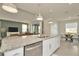 Open kitchen with granite countertop island, stainless appliances, and view of the dining and living areas at 3504 Golden Wheat Ln, Plant City, FL 33565