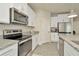 Modern kitchen with stainless steel appliances, granite countertops and white cabinetry providing a clean, stylish look at 3504 Golden Wheat Ln, Plant City, FL 33565