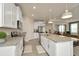 Well-lit kitchen featuring white cabinets, granite countertops, stainless steel appliances, and an open layout at 3504 Golden Wheat Ln, Plant City, FL 33565