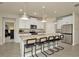 Stylish kitchen with a large island, granite countertops, modern pendant lighting, and barstool seating at 3504 Golden Wheat Ln, Plant City, FL 33565