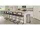 Modern kitchen island with barstools, granite countertops, stainless steel appliances, and sleek white cabinetry at 3504 Golden Wheat Ln, Plant City, FL 33565