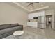 Stylish kitchenette featuring a stainless steel refrigerator, white cabinets, and a gray sofa at 3504 Golden Wheat Ln, Plant City, FL 33565