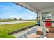 Relaxing lanai with lake view, stylish rug, and comfortable outdoor furniture, perfect for enjoying the serene scenery at 3504 Golden Wheat Ln, Plant City, FL 33565