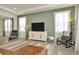 Well-lit living room with olive green walls, modern decor and furniture, and water views at 3504 Golden Wheat Ln, Plant City, FL 33565