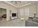 Bright living room featuring a modern sofa, built-in bookshelves, and an open doorway to the bedroom at 3504 Golden Wheat Ln, Plant City, FL 33565