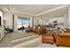 Open concept living room with a leather sectional, chairs, and views of the water at 3504 Golden Wheat Ln, Plant City, FL 33565