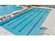 A beautiful, long swimming pool features lane markers and lounge chairs at 3504 Golden Wheat Ln, Plant City, FL 33565