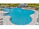 A large community pool with an exciting water slide and lounge chairs for relaxing at 3504 Golden Wheat Ln, Plant City, FL 33565