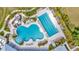 Aerial view showcasing the resort-style pool featuring a water slide and lap lanes surrounded by lush greenery at 3504 Golden Wheat Ln, Plant City, FL 33565