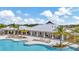 Beautiful pool and pool house surrounded by palm trees under a blue sky at 3504 Golden Wheat Ln, Plant City, FL 33565