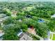 Aerial view of a neighborhood with mature trees, community ponds, and well-kept lawns at 4215 Water Oaks Ln, Tampa, FL 33618
