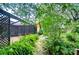 Backyard stone pathway leading to a screened lanai and lush landscaping at 4215 Water Oaks Ln, Tampa, FL 33618
