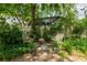 Serene backyard featuring two inviting wooden benches, a perfect spot for relaxation and enjoying nature at 4215 Water Oaks Ln, Tampa, FL 33618