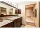 Bathroom with vanity, sink, and a tiled shower with glass enclosure at 4215 Water Oaks Ln, Tampa, FL 33618