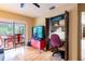 Cozy home den with workspace featuring views to the screened lanai and backyard beyond at 4215 Water Oaks Ln, Tampa, FL 33618
