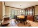 This dining room features an oval table, comfortable seating, a large window, and a handsome china cabinet at 4215 Water Oaks Ln, Tampa, FL 33618