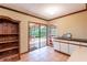 Bright breakfast nook features a bookcase, cabinets, and view to an outdoor patio at 4215 Water Oaks Ln, Tampa, FL 33618