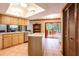 An airy kitchen with an island, wood cabinets and easy access to screened outdoor dining at 4215 Water Oaks Ln, Tampa, FL 33618