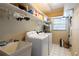 Laundry room with a washer, dryer, sink, and plenty of storage space at 4215 Water Oaks Ln, Tampa, FL 33618