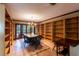 This charming library boasts floor-to-ceiling shelving, a chandelier, and outdoor access to a garden at 4215 Water Oaks Ln, Tampa, FL 33618