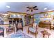 Open-concept living room featuring a built-in bar, custom bookcases, and tile flooring at 4215 Water Oaks Ln, Tampa, FL 33618
