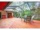 Charming screened patio with a wooden deck and outdoor dining space at 4215 Water Oaks Ln, Tampa, FL 33618