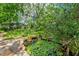 Beautiful backyard pond with lush greenery, lily pads, and a stone path, creating a peaceful oasis at 4215 Water Oaks Ln, Tampa, FL 33618