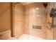 Modern tiled shower with glass door, niche, and elegant fixtures at 4215 Water Oaks Ln, Tampa, FL 33618