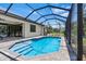 Stunning pool area with a screened enclosure and a paved deck that provides ample space for outdoor enjoyment at 4323 Baynes Rd, North Port, FL 34288
