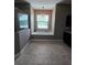 Elegant bathroom features a soaking tub under a window with decorative chandelier at 4323 Baynes Rd, North Port, FL 34288