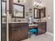 Bathroom featuring dual vanities, makeup vanity, and neutral-toned tile flooring at 4323 Baynes Rd, North Port, FL 34288