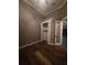 Bedroom with wood floors and closet, accented by a glass-paned door at 4323 Baynes Rd, North Port, FL 34288
