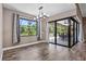 Dining room boasts wood-look tile flooring, and sliding glass doors leading to the backyard at 4323 Baynes Rd, North Port, FL 34288