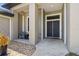 Inviting entrance featuring a cozy sitting area and double doors that lead into the home at 4323 Baynes Rd, North Port, FL 34288