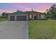 Charming single-story home featuring a spacious three-car garage and well-manicured lawn at 4323 Baynes Rd, North Port, FL 34288