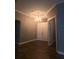 Welcoming foyer with a chandelier and entry to the home with double doors at 4323 Baynes Rd, North Port, FL 34288