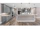 Modern kitchen features gray cabinets, granite countertops, and stainless steel appliances at 4323 Baynes Rd, North Port, FL 34288