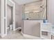 Elegant bathroom featuring a glass-enclosed shower and separate toilet room, showcasing modern design at 4323 Baynes Rd, North Port, FL 34288