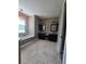 Spacious bathroom with dual vanities, granite counters, and a freestanding tub under a chandelier at 4323 Baynes Rd, North Port, FL 34288