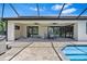Beautiful screened-in patio with outdoor dining and pool access at 4323 Baynes Rd, North Port, FL 34288