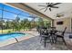 Screened-in patio features an outdoor seating area and swimming pool at 4323 Baynes Rd, North Port, FL 34288