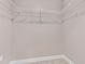 Walk-in closet with white wire shelving and neutral carpeting, offering a practical storage solution at 4323 Baynes Rd, North Port, FL 34288