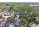 An aerial view of a home highlighting its lush surroundings and curb appeal from an elevated perspective at 4368 Marine Pkwy, New Port Richey, FL 34652