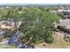 An aerial view of a home highlighting its lush surroundings and curb appeal from an elevated perspective at 4368 Marine Pkwy, New Port Richey, FL 34652