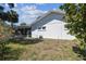 Image of the side yard and exterior of a home with a screened-in patio at 4368 Marine Pkwy, New Port Richey, FL 34652