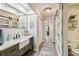 Bathroom with a large vanity, stylish mirror, and barn door access to the hall at 4368 Marine Pkwy, New Port Richey, FL 34652